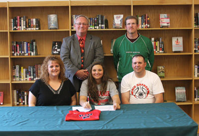 Winfield High's Mara Rhoades poses with her parents and coaches after signing to play basketball at Rio Grande